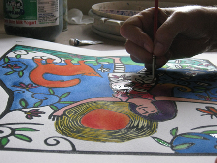 close up of meg's hand, painting a lino print, very bright art