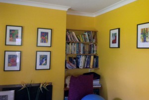 Daffodil yellow walls featuring several Tangerine Meg art prints